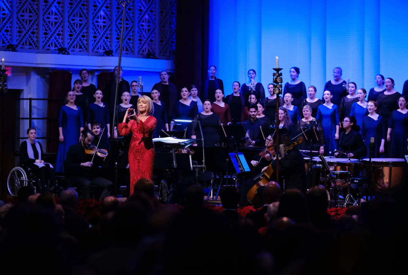 Conducting the full choir in Mees Hall, in a red gown